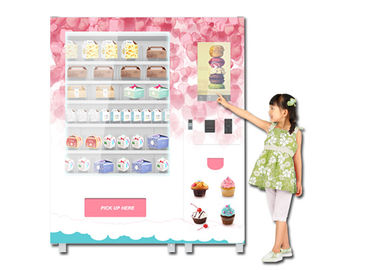 作動する硬貨食糧自動販売機、カップケーキのパンの軽食の自動販売機を広告します